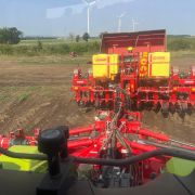 Cab view from a Claas Xerion of a Grimme planter steered with ValveMaster-Bridge