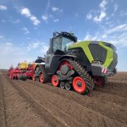Claas Xerion 12.650 on tracks with Grimme planter, John Deere receiver on the cab